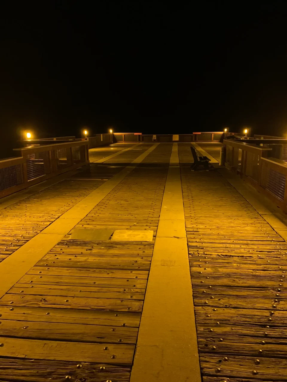 Close view of pier deck and rail lighting after dark at Casino Beach