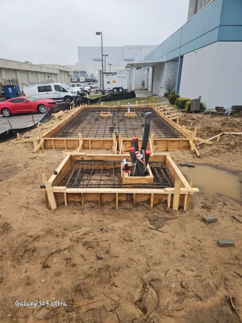Rebar and conduit stub-ups set in forms before an equipment pad pour