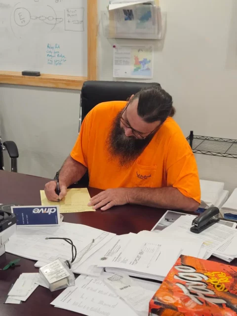 Crew lead reviewing drawings and project paperwork