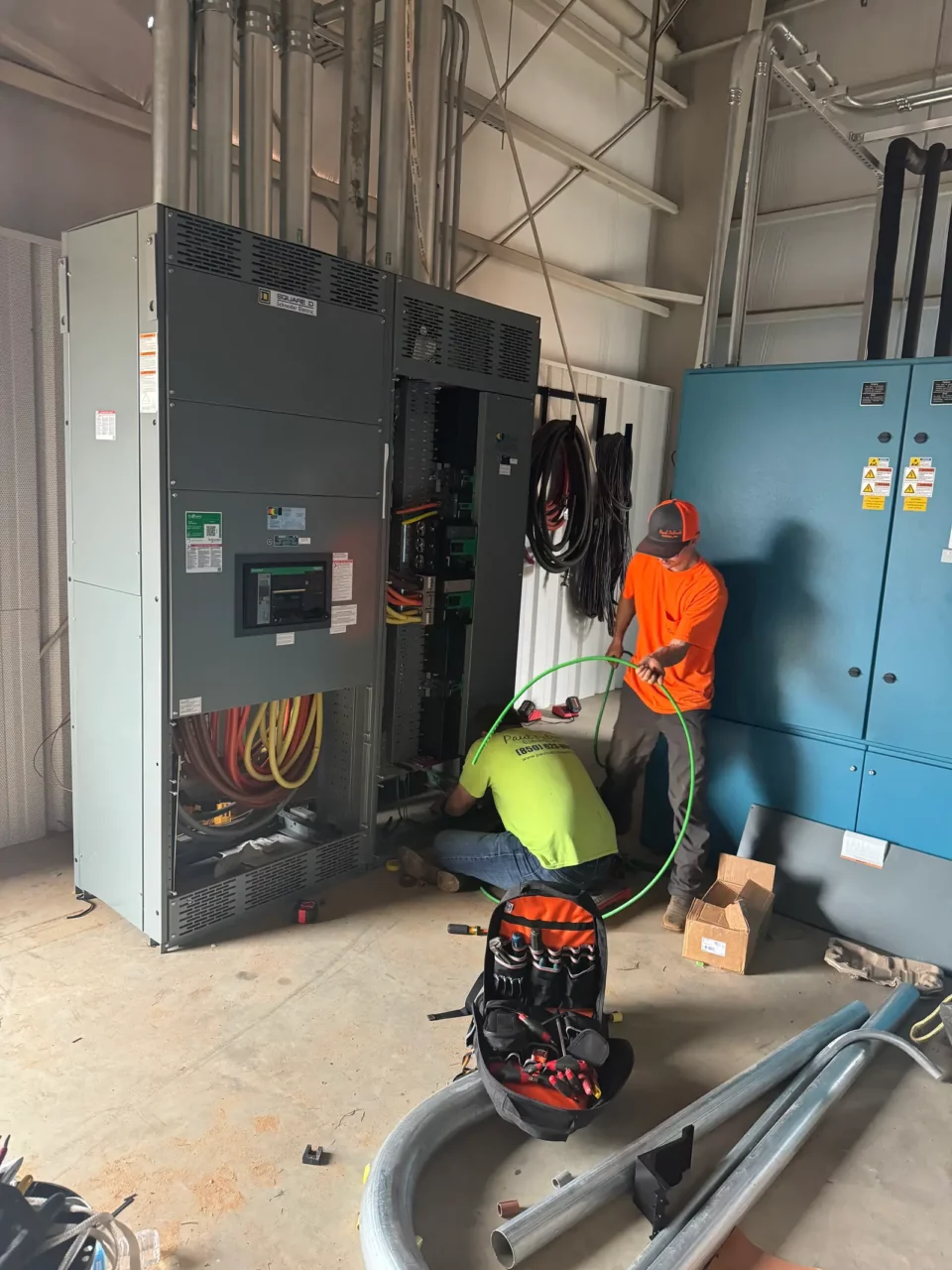 Paul Patrick Electric crew installing switchgear in an equipment room at Eglin Air Force Base